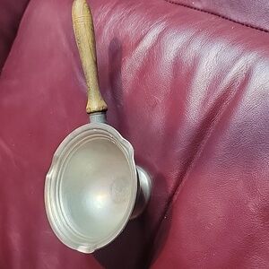 Vintage Pewter pouring bowl with wooden handle.